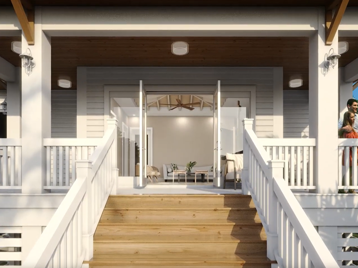 A bright white porch with wide wooden steps leads to double glass doors; balconies on both sides frame a modern house exterior, with a person standing on the right balcony.